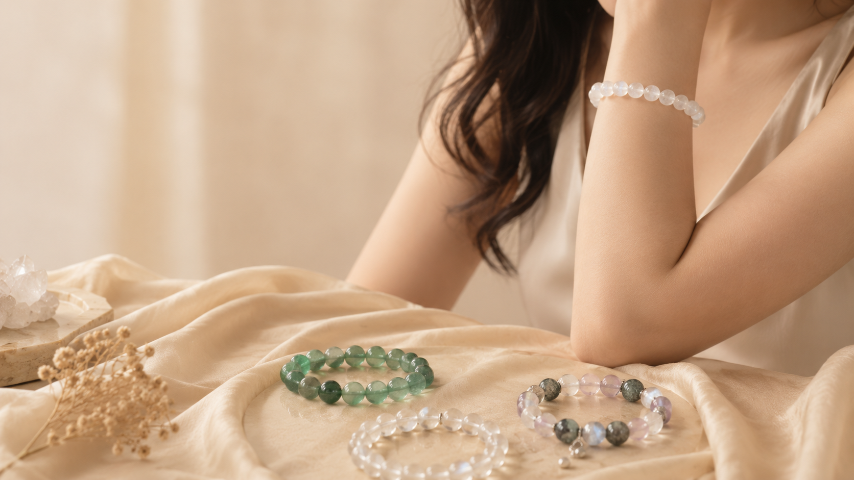 Warm crystal bracelet lifestyle scene with a model and multiple bracelet options