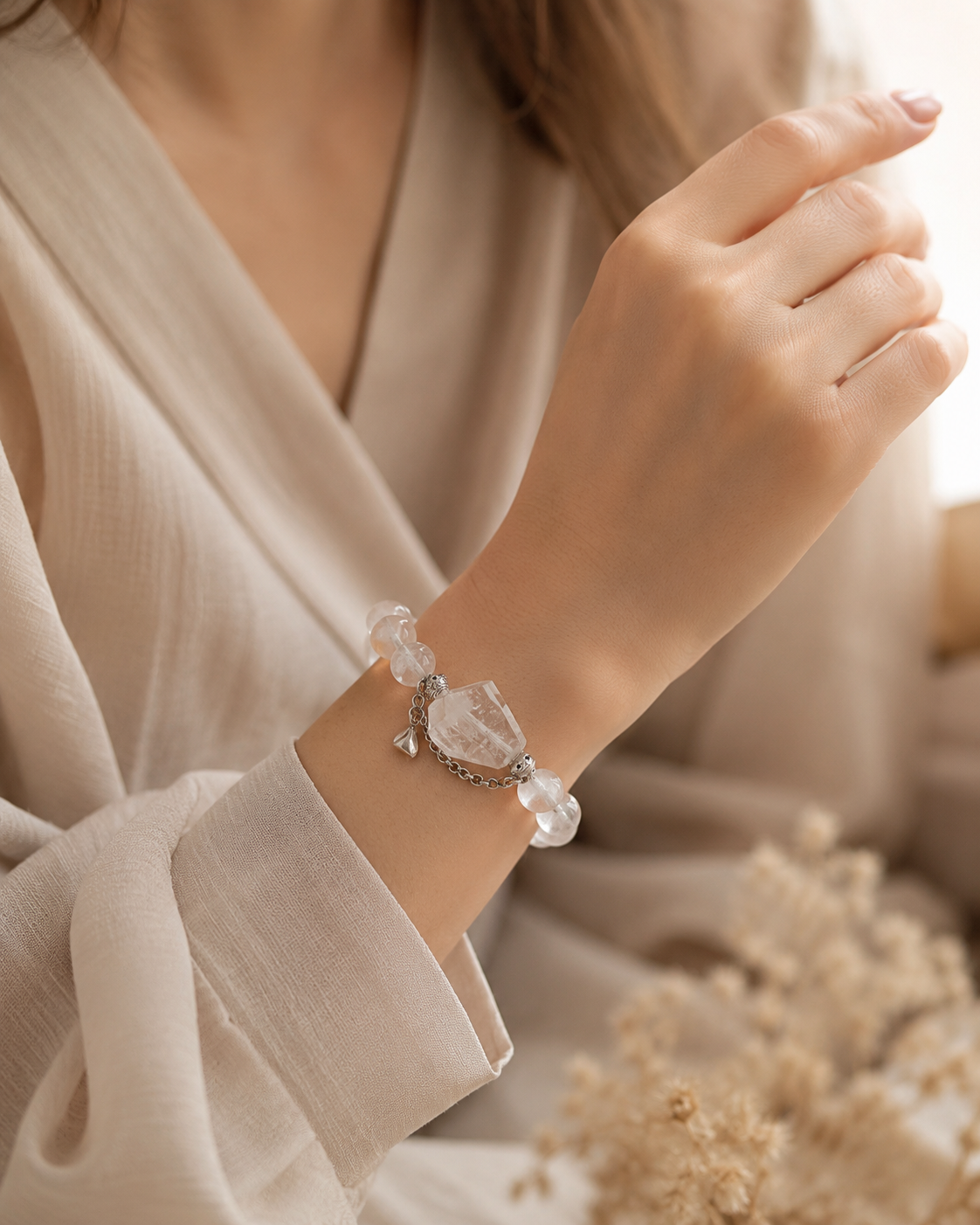 Hand holding a crystal bracelet in a soft lifestyle scene